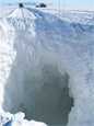 The South Pole Traverse team fills an open crevasse in what is called the shear zone, an area with hundreds of crevasses.