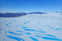 Meltwater lakes on the surface of the George VI Ice Shelf, Antarctic Peninsula, in January 2020. Photo by Thomas Simons.