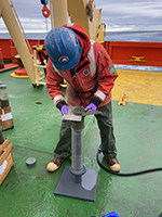 Sectioning a sediment core collected from the Antarctic continental shelf.
Photograph by Deric Learman 
