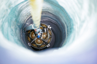 An mDOM is lowered into a borehole. Photo by Yuya Makino, IceCube/NSF