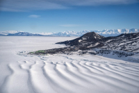 The McMurdo Ice Shelf Rumples with Scott Base behind. Photo by Ali Banwell.