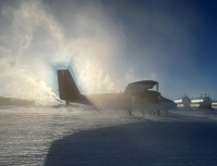A Twin Otter in the snow and misty air. Photo by Zane Ziebell, courtesy of the USAP Photo Library.